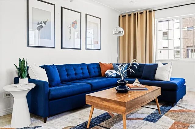 a living room with furniture and a potted plant