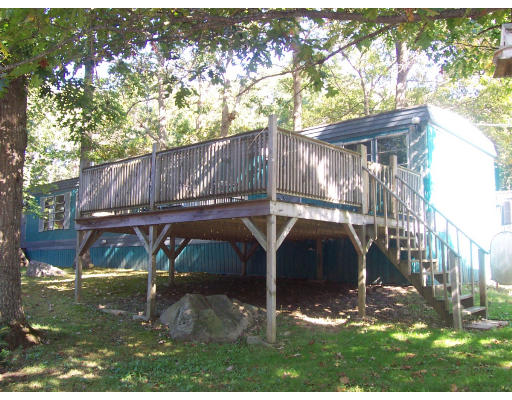 301-58 Bulgarmarsh Road Tiverton, RI 02878 - Photo 3 of 8 a view of a small house with yard and sitting area