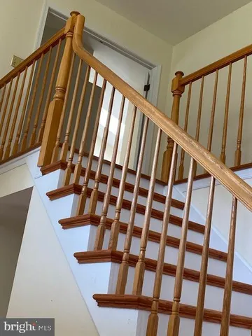 a view of staircase with lots of white walls and a window