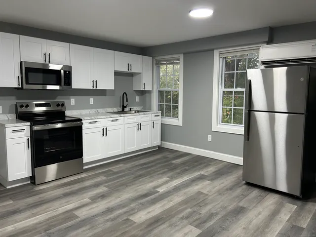 a kitchen with stainless steel appliances granite countertop a refrigerator stove a sink and dishwasher