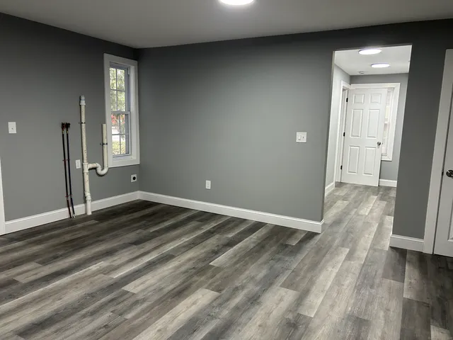 wooden floor in an empty room with a window