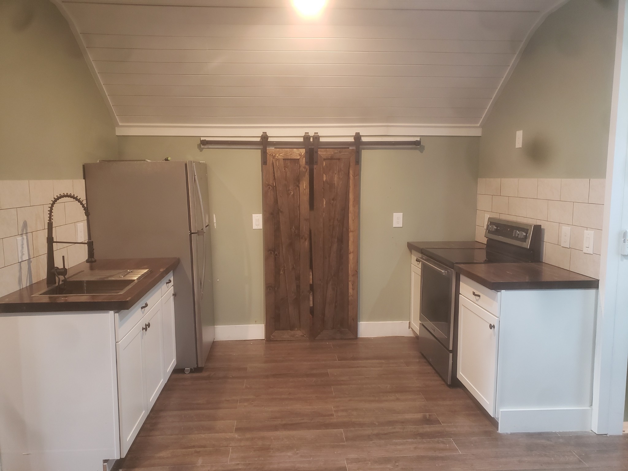 595 Aplin Branch Road Cottontown, TN 37048 - Photo 8 of 8 a kitchen with stainless steel appliances granite countertop a sink and a refrigerator