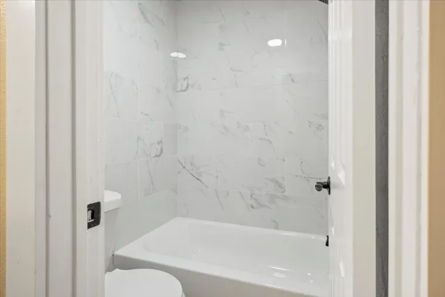 a bathroom with a bathtub and a toilet