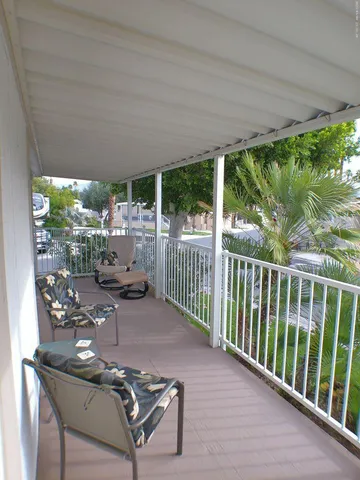 a view of balcony with furniture and garden