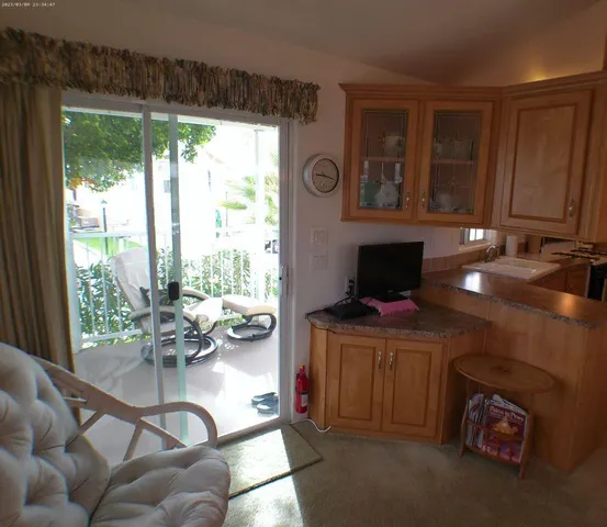 a kitchen with a table chairs refrigerator and microwave