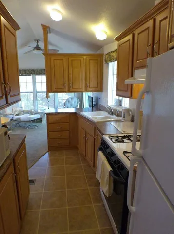 a kitchen with a sink and a stove top oven