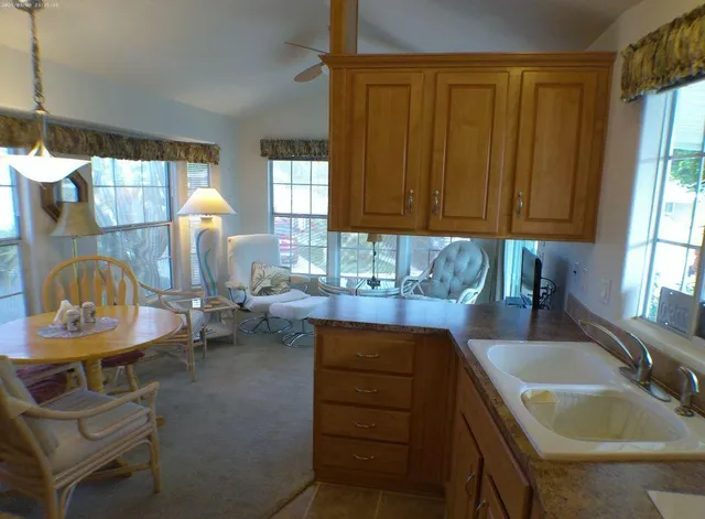 a kitchen with granite countertop a refrigerator and a stove top oven