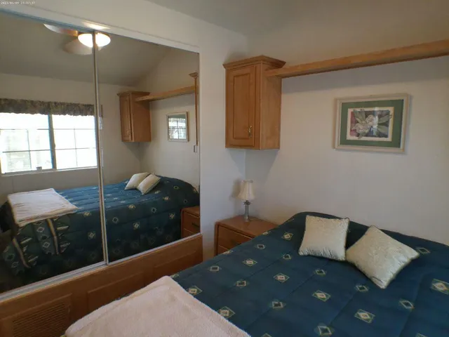 a bedroom with a bed and cabinets