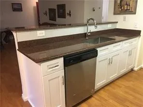 a kitchen with a sink and cabinets