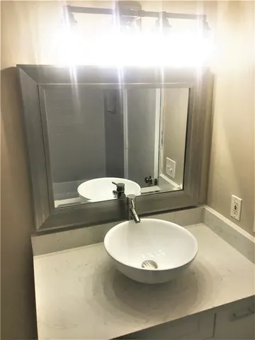 a bathroom with a mirror and a sink