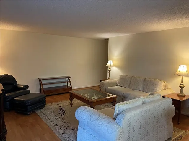 a living room with furniture and a lamp