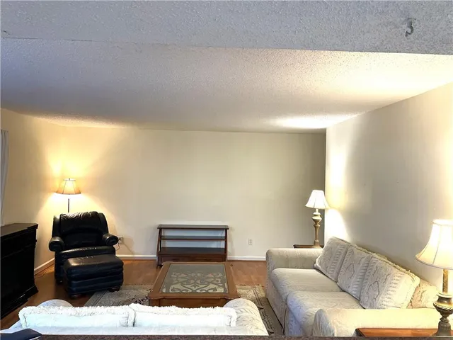 a living room with furniture and a lamp