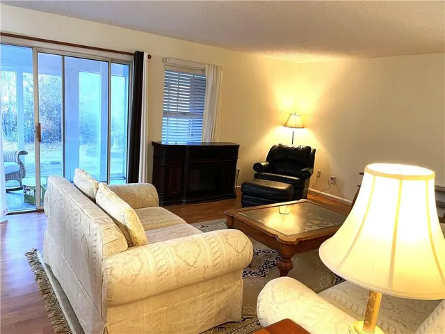 a living room with furniture and a lamp