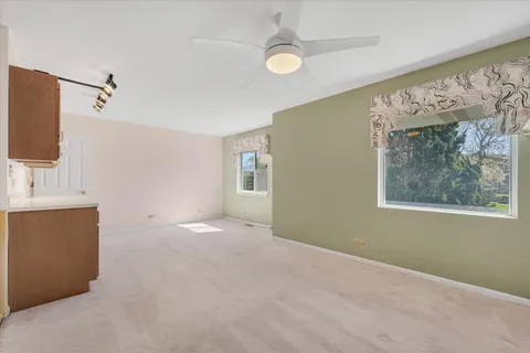 a view of a room with a ceiling fan and a shower