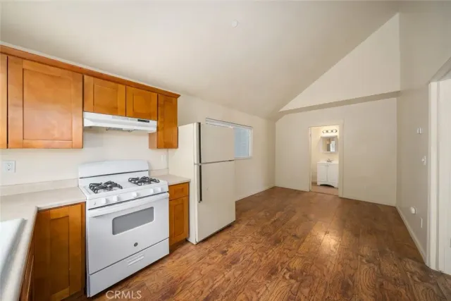 a kitchen with a stove a sink and a refrigerator
