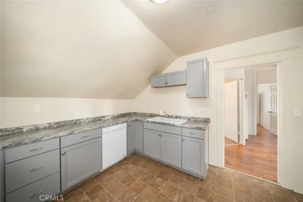 a kitchen with a stove top oven and refrigerator