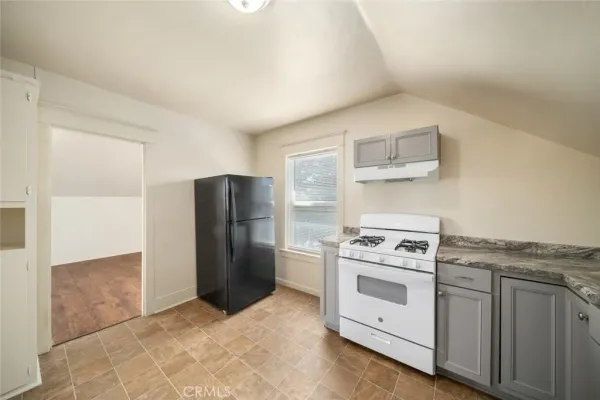 a kitchen with a stove top oven sink and cabinets