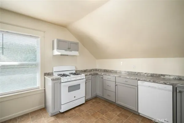 a kitchen with a sink a refrigerator and cabinets