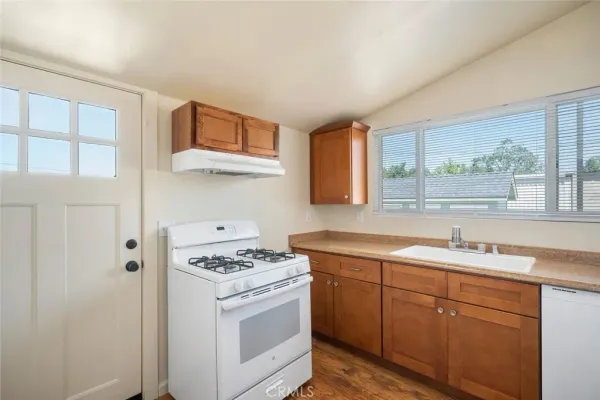 a kitchen with a sink stove and cabinets