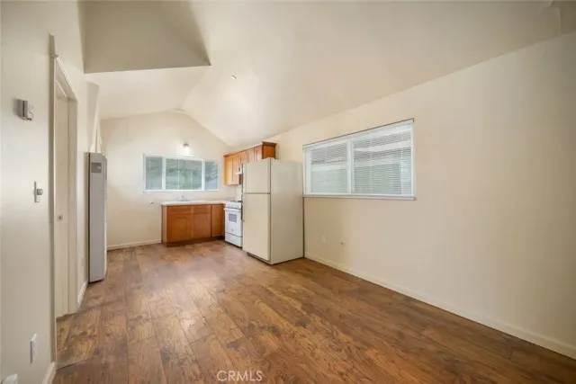 a view of a kitchen with a refrigerator a microwave and a sink