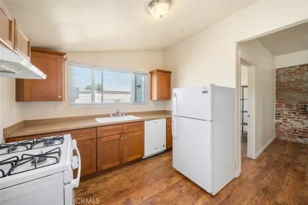 a kitchen with a refrigerator stove and sink