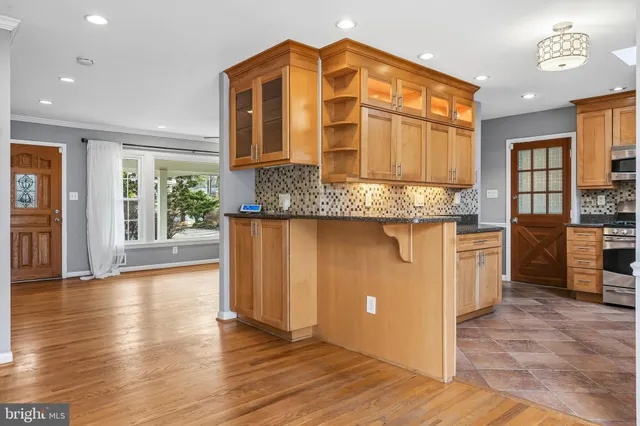 a view of a roof deck with table and chairs couches with wooden floor and fence