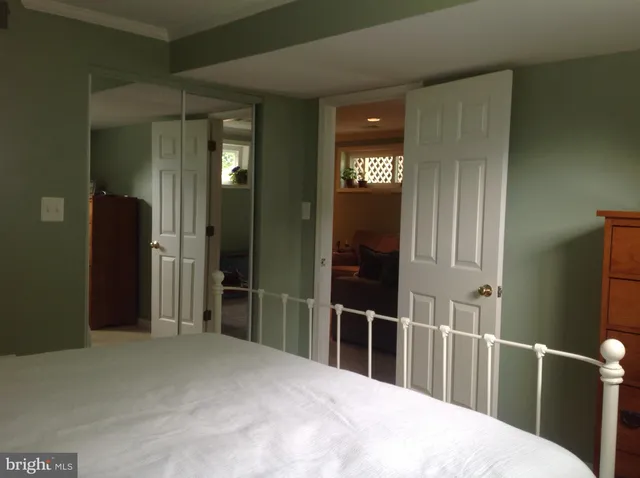 a bedroom with a bed and a mirror