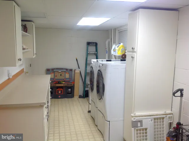 a view of a workspace with furniture and wooden floor