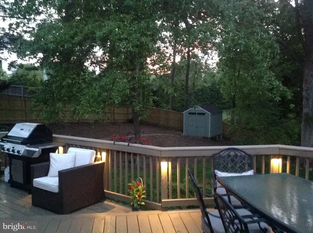 a view of a deck with couches and a fire pit
