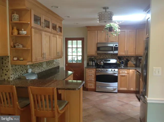 a kitchen with cabinets and appliances