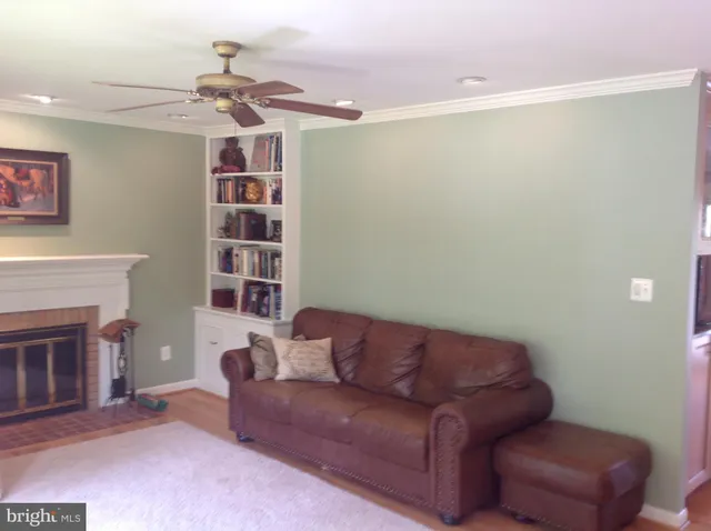 a living room with furniture a fireplace and a chandelier