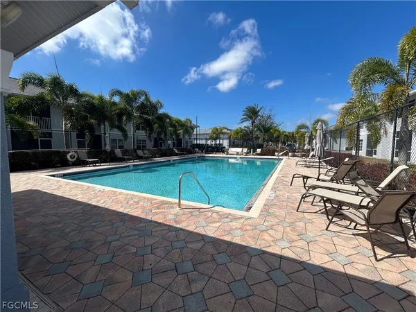 a view of a swimming pool and lounge chairs