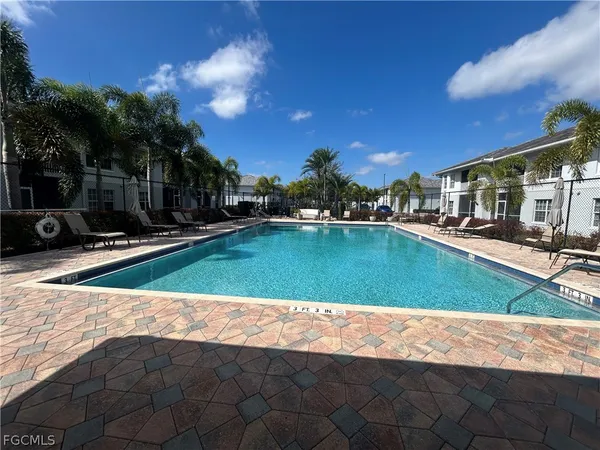 a view of a swimming pool with an outdoor space and seating area