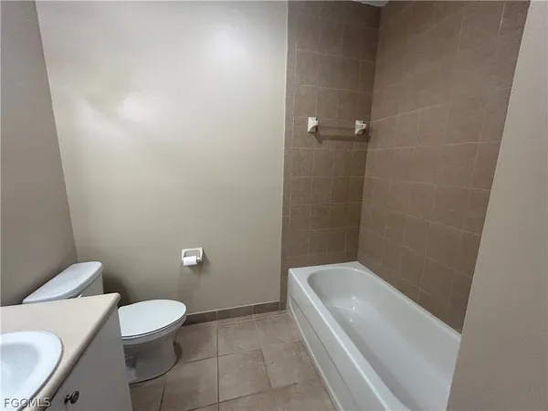 a white toilet sitting next to a white sink