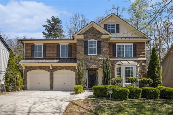 a front view of a house with garden
