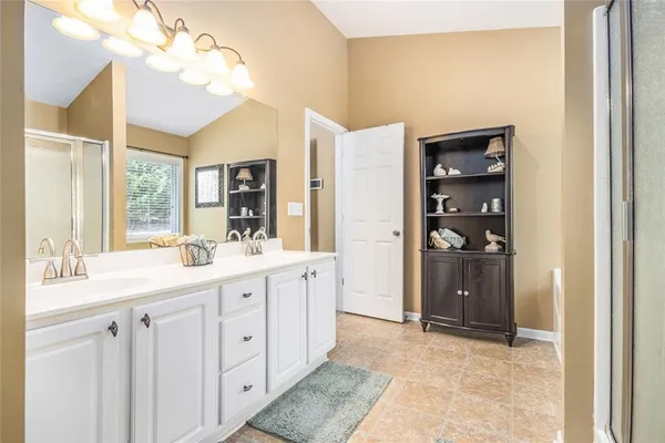 a spacious bathroom with a double vanity sink and a mirror