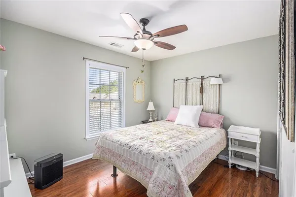 a bedroom with a bed and wooden floor