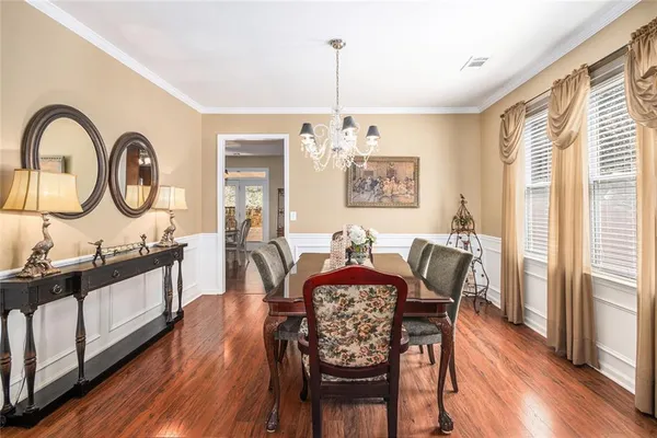 a view of a a dining room with furniture window and wooden floor
