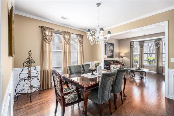 a view of a dining room with furniture window and wooden floor