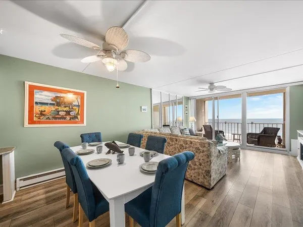 a view of a dining room with furniture window and wooden floor