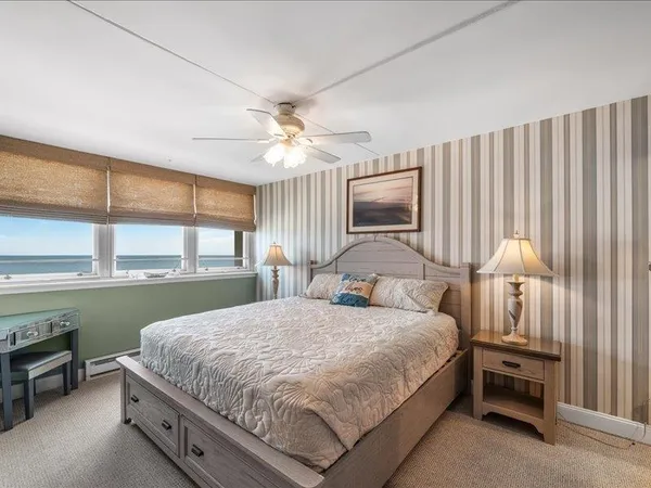a bedroom with a bed mirror and a window