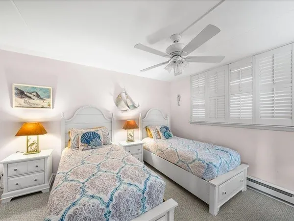 a bedroom with a bed and a flat tv screen on dresser