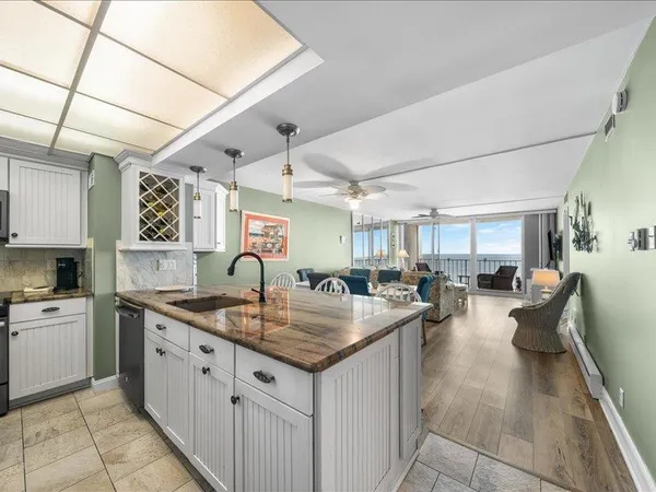 a kitchen with sink cabinets and living room