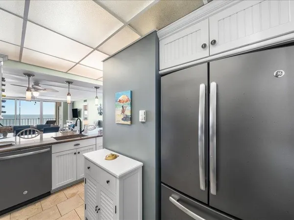 a kitchen with refrigerator and sink