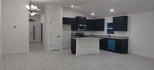 a kitchen with kitchen island a sink stainless steel appliances and cabinets