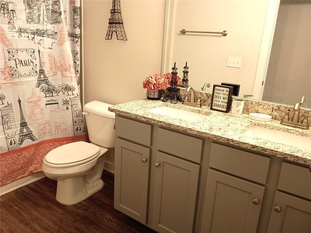 807 Ridgeview Court Hampton, GA 30228 - Photo 52 of 69 a bathroom with a granite countertop toilet sink and mirror