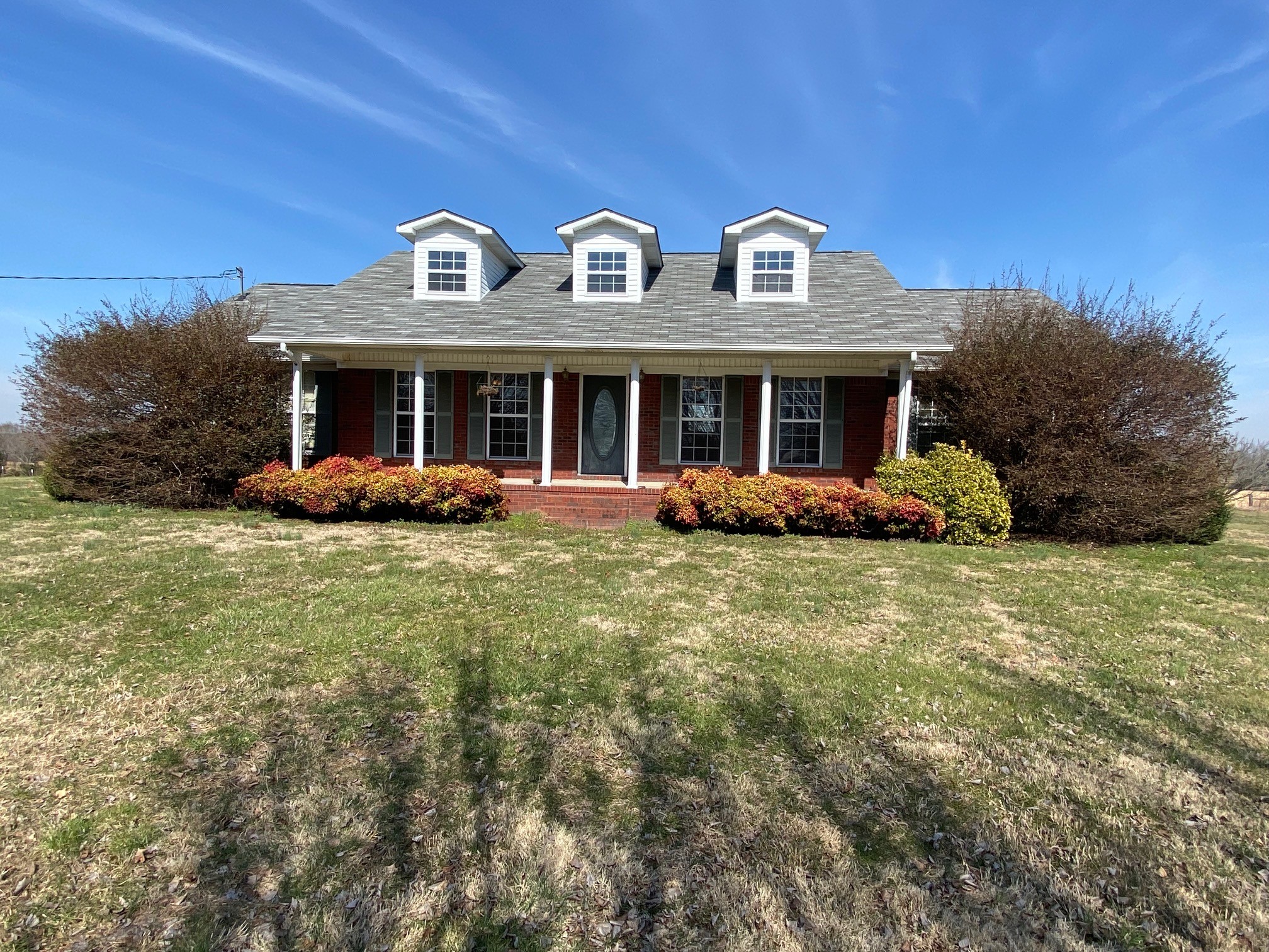 1190 Powell School Road Goodspring, TN 38460 - Photo 1 of 27 a front view of a house with garden