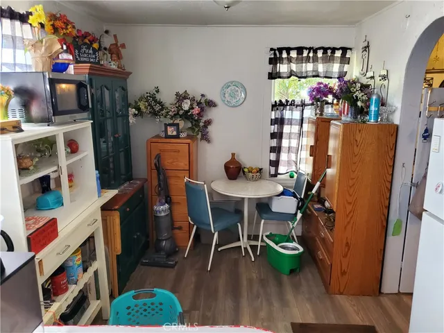 a view of a dining room with furniture and a potted plant