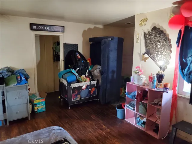 a living room with baby toys and wooden floor