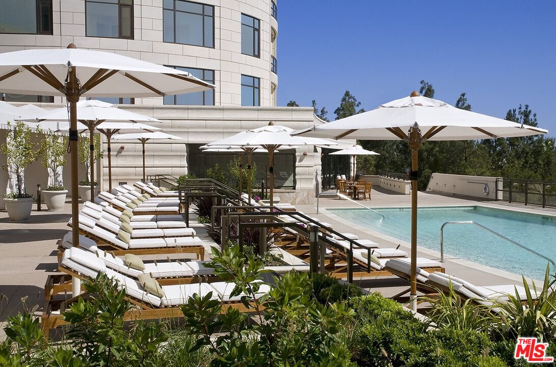 1 West Century Drive, Unit PH 38B Los Angeles, CA 90067 - Photo 4 of 5 a view of a patio with table and chairs potted plants with wooden fence